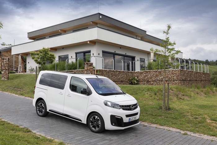 White Opel Zafira Life Minivan in front of a modern house