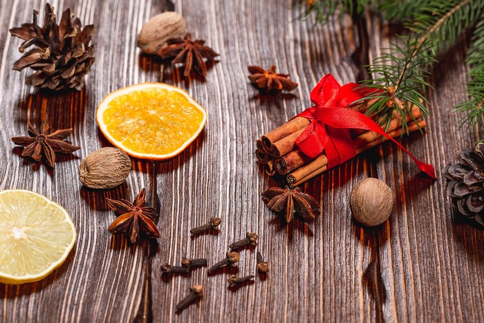 Christmas spices and decorations on wooden planks