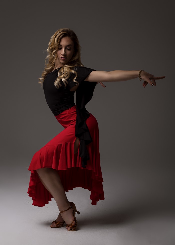 Blonde dancer in red skirt poses