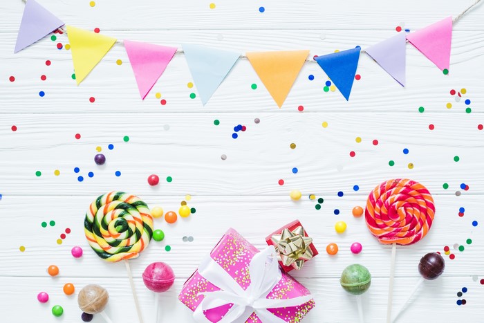Birthday party with lollipops, confetti, and gifts