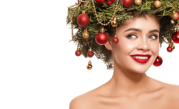 Woman with Christmas tree ornaments in hair