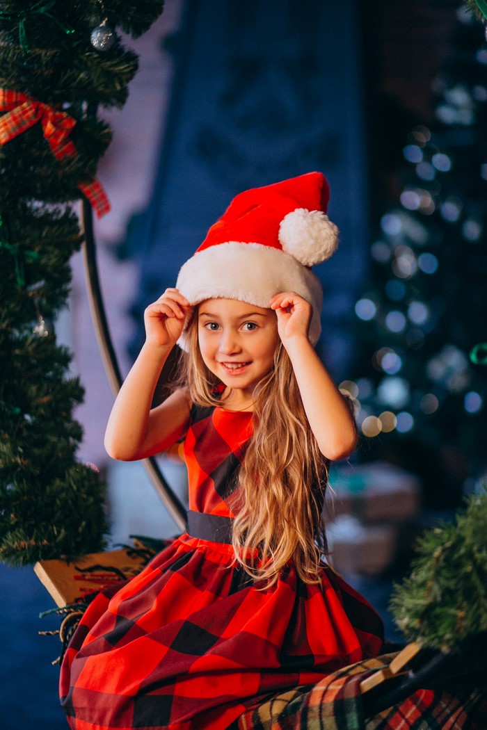 Girl in Santa hat and Christmas dress