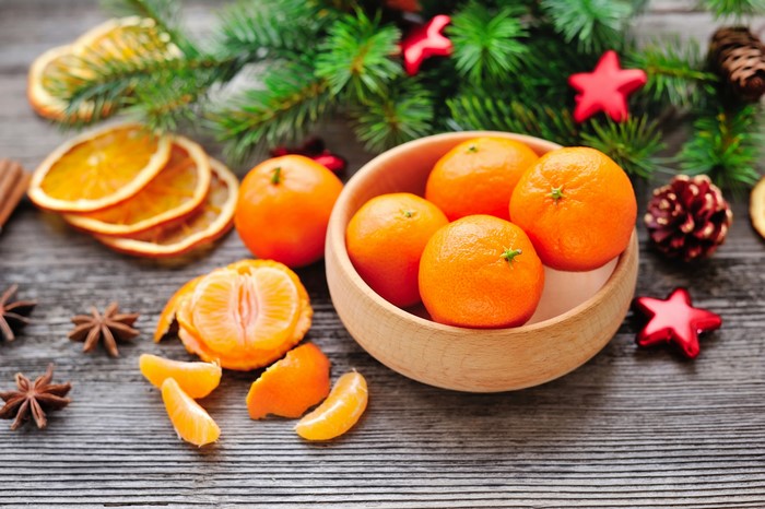 Christmas still life with tangerines and fir branches