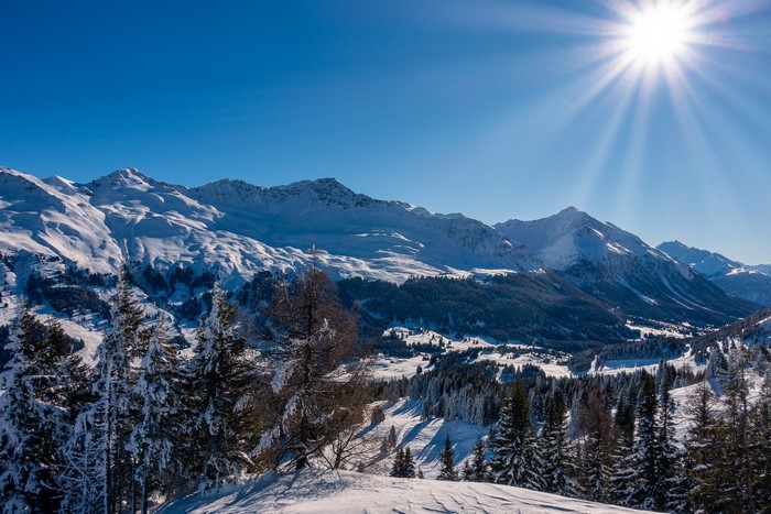 Snowy Mountains in Switzerland with Sun Rays