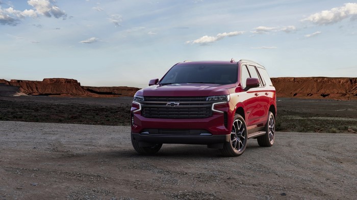 Red Chevrolet Tahoe SUV in a desert landscape