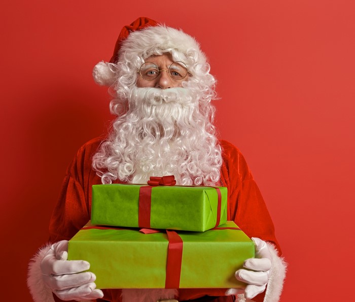 Santa Claus holding green gifts