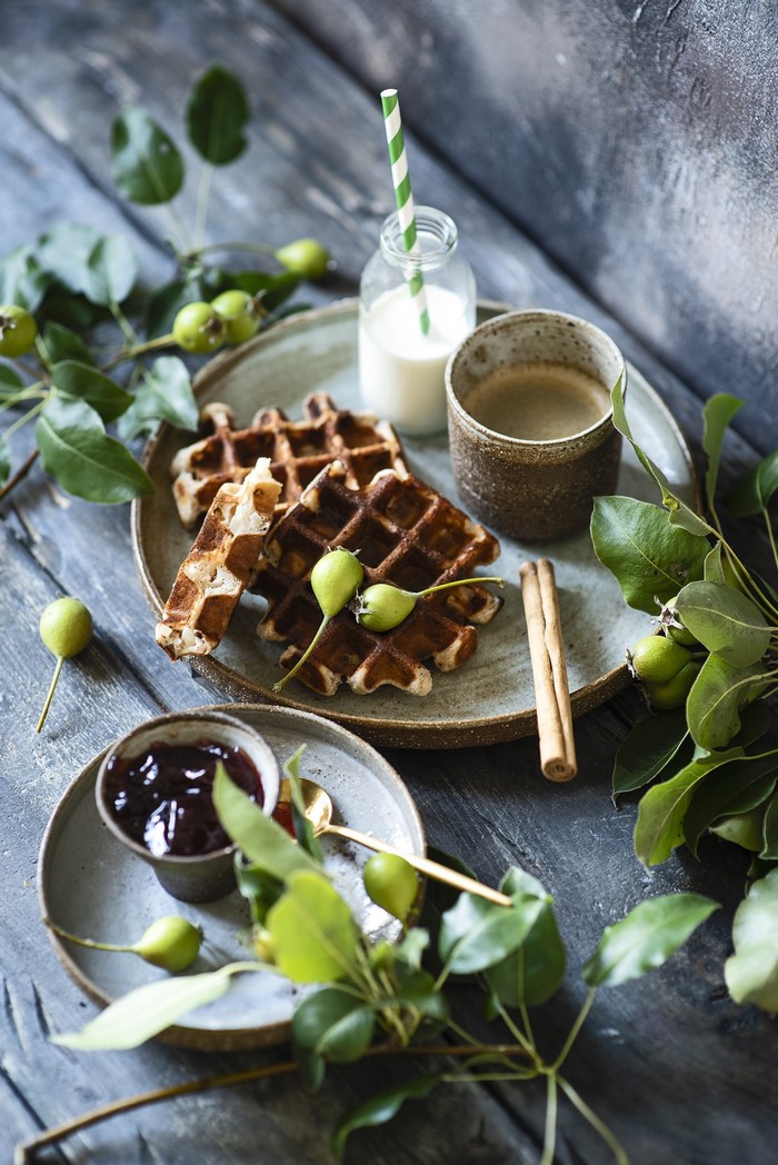 Waffles with pears, jam, coffee, and milk