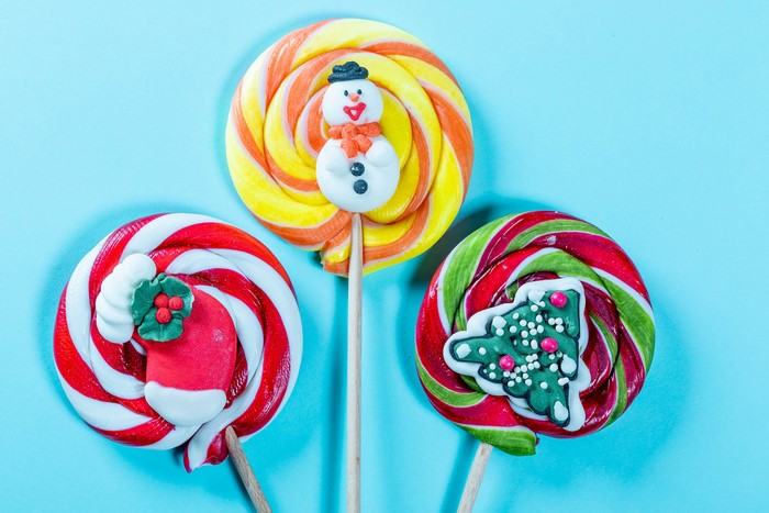 Three Christmas lollipops on a blue background