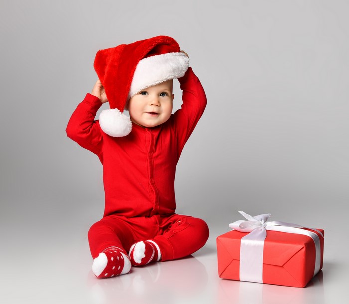 Baby in Santa hat with Christmas gift