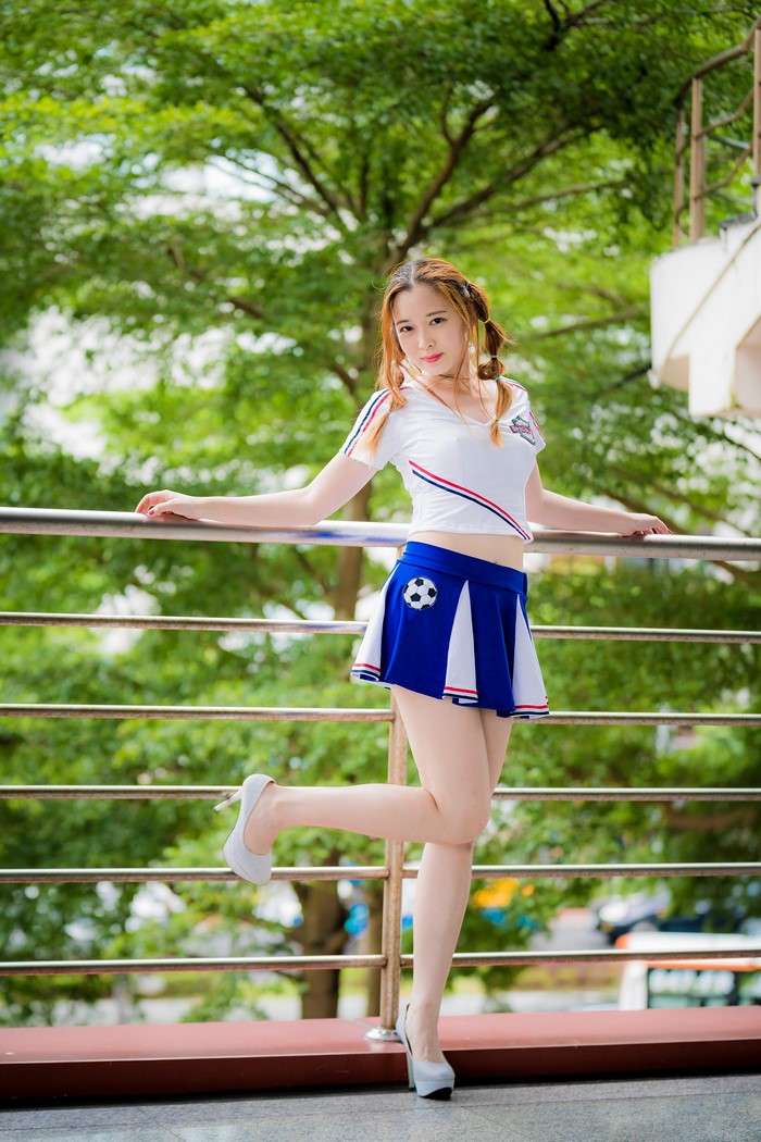 Asian Woman Posing in Blue Skirt and White T-shirt