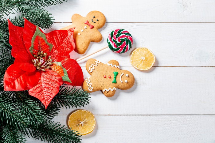 Christmas cookies and poinsettia on wood