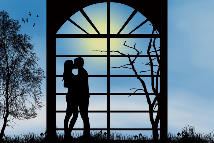 Couple kissing in a window silhouette