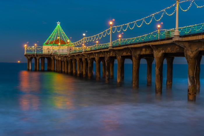 Manhattan Beach Pier decorated with Christmas lights at dusk