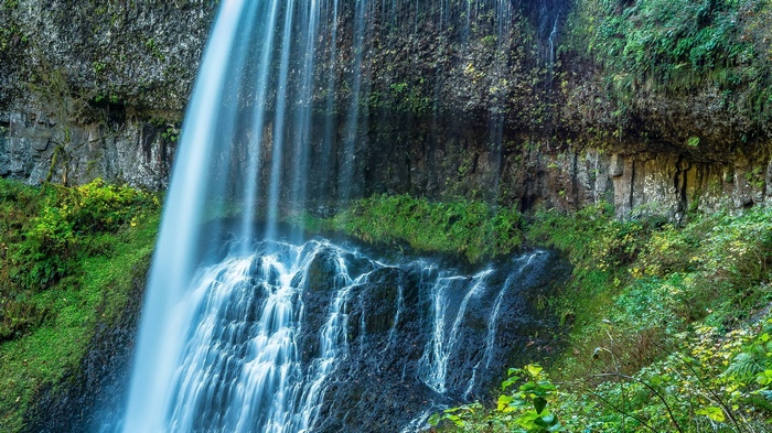 Waterfall cascading over mossy rocks