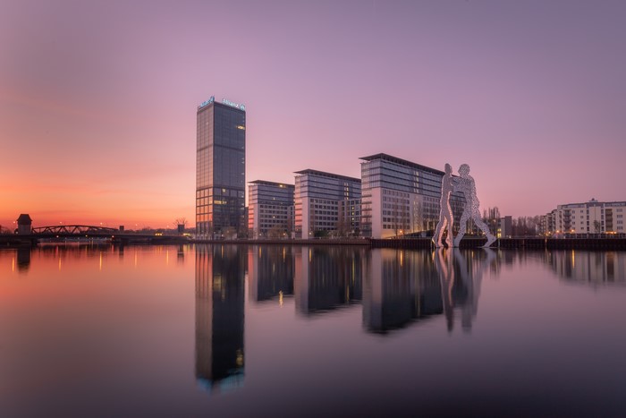 Berlin skyline with Allianz building and sculpture at sunset