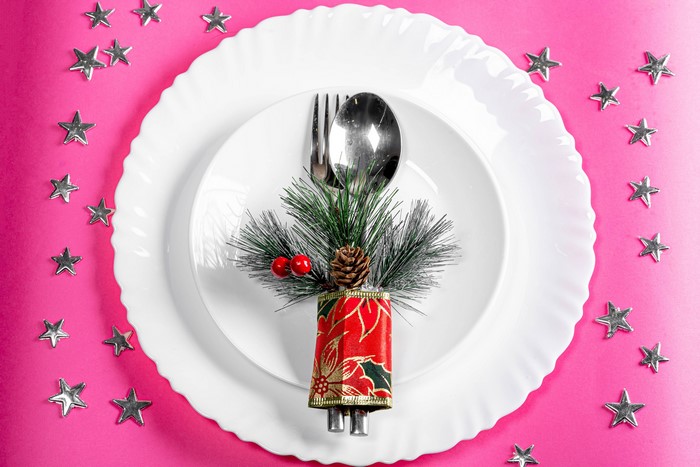 Christmas table setting with pine cone and berries