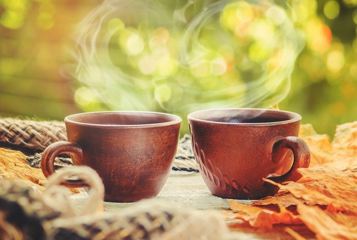 Two cups of coffee with steam