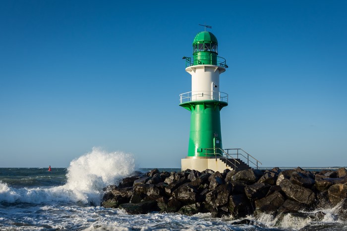 Lighthouse on a rocky shore with waves in Germany