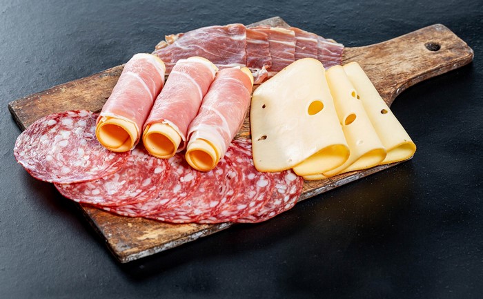 Charcuterie board with ham, cheese, and salami