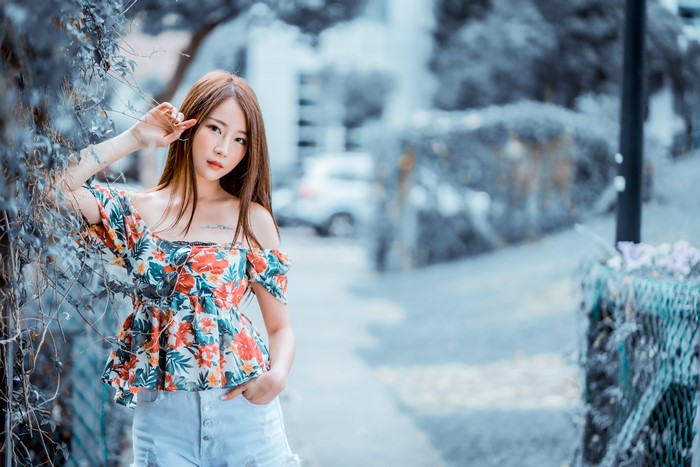 Asian woman with brown hair in floral top