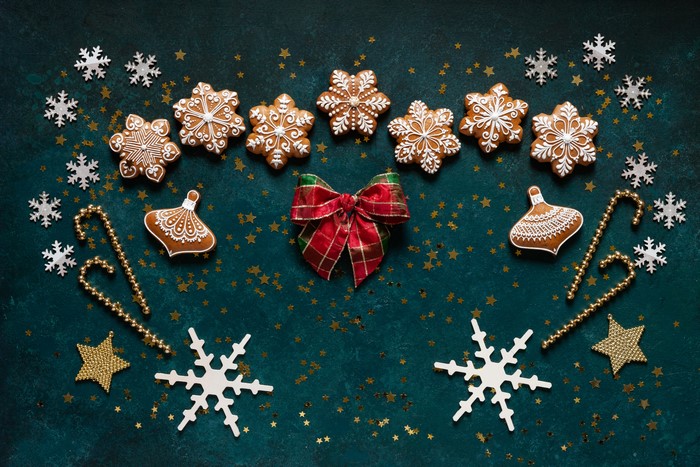 Christmas cookies, snowflakes, and candy canes on a dark background