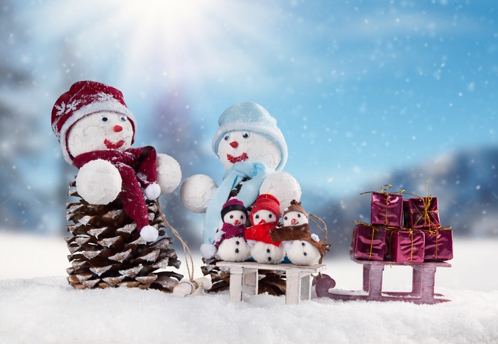Christmas snowmen with gifts on a sled