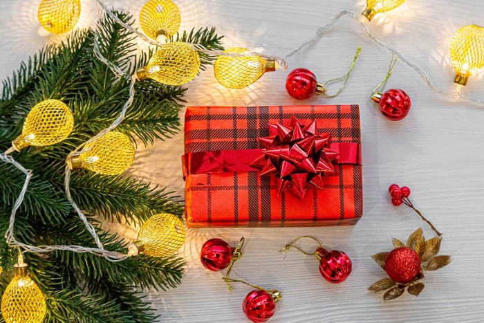 Christmas gift with pine branches and fairy lights