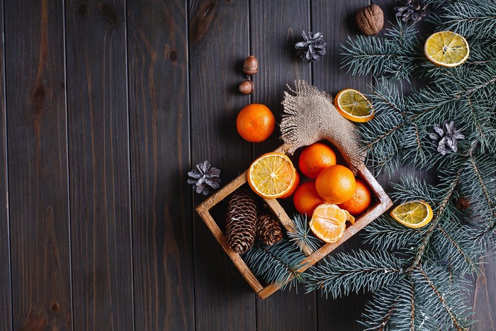 Christmas still life with tangerines and pine cones