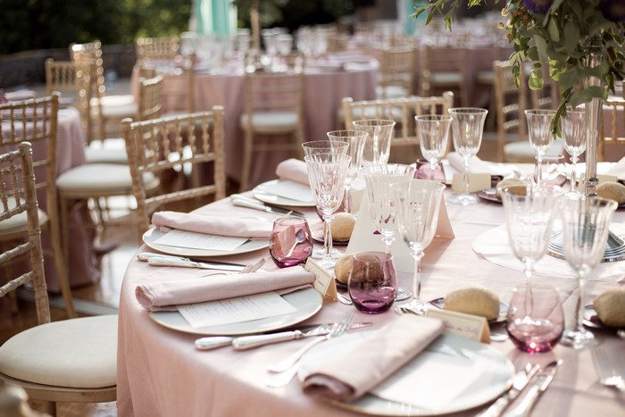 Table setting with pink tablecloth and chairs