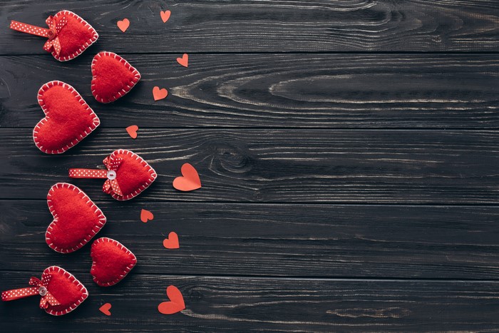 Red hearts on dark wood planks, Valentine's Day template