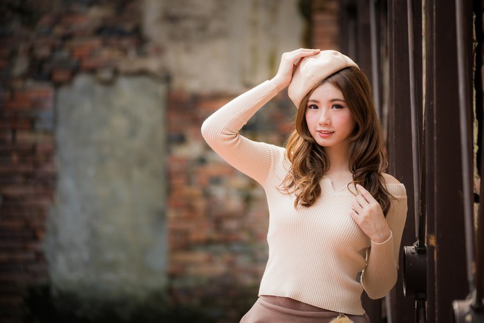 Asian woman with brown hair wearing a beret