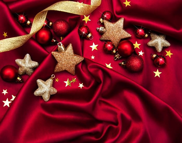 Christmas ornaments and ribbon on red satin