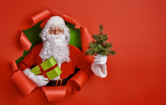 Santa Claus Holding Christmas Tree and Gift 4K