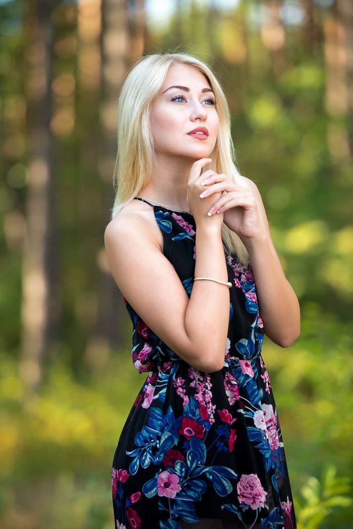Nastya in a floral dress with blonde hair