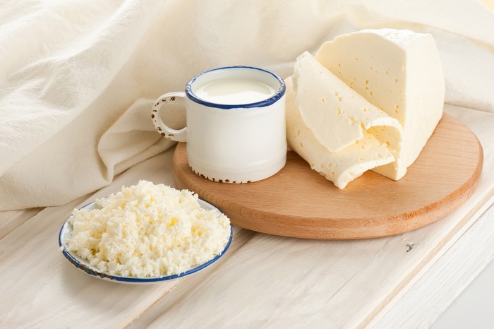Milk, Cheese, and Quark Curd on a Cutting Board
