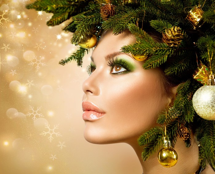 Woman with Christmas tree branches and ornaments