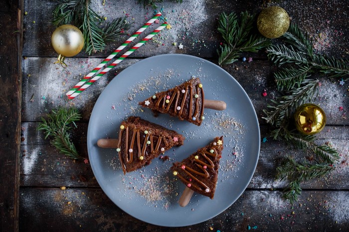 Christmas tree brownies on a plate with decorations