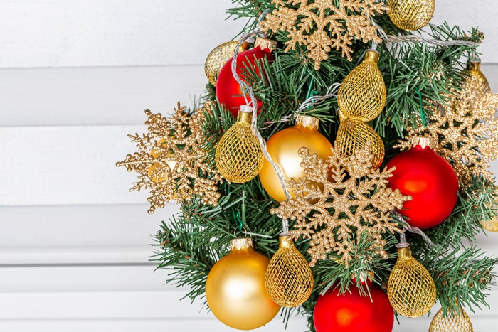 Christmas tree with red and gold ornaments and snowflakes