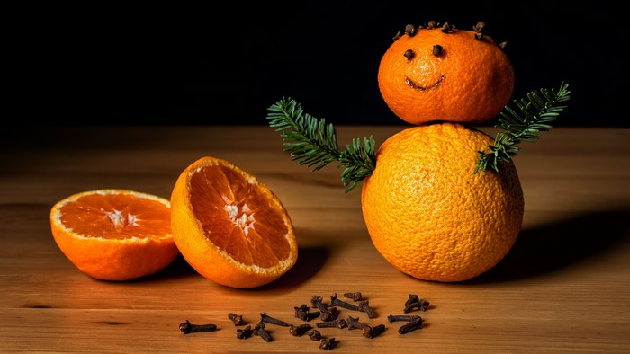 Orange snowman with cloves and pine branches