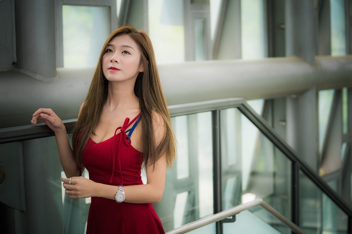 Asian woman in red dress with brown hair