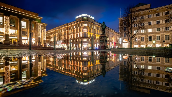 Stuttgart town square at night with reflections in a puddle