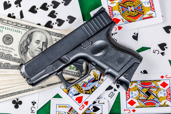 Pistol, Dollars, and Playing Cards