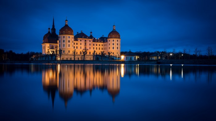 Schloss Moritzburg reflected in a lake at night