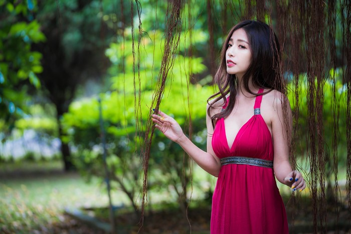 Asian woman in a pink dress in a garden