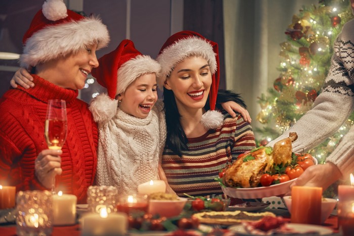 Family celebrating Christmas dinner with roasted turkey