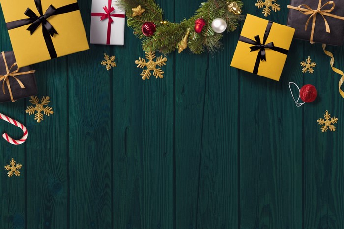 Christmas gifts and decorations on dark wood