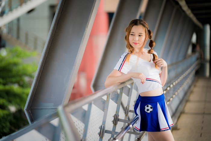 Asian girl in cheerleader outfit with pigtails