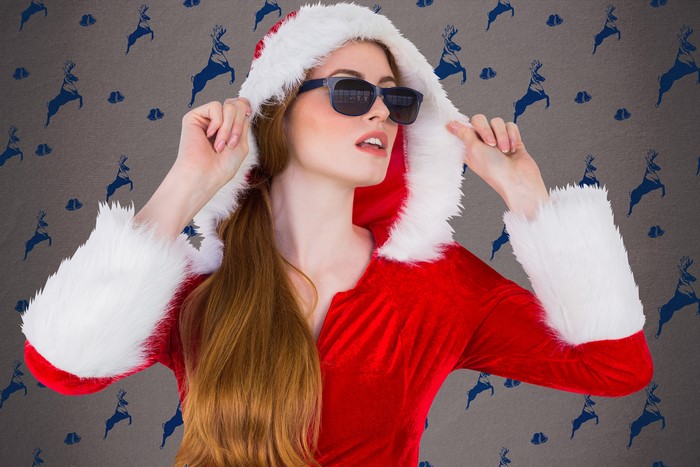 Woman in Santa costume with sunglasses