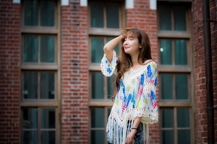 Asian woman with brown hair posing
