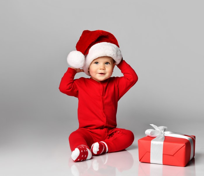 Baby in Santa hat with Christmas gift